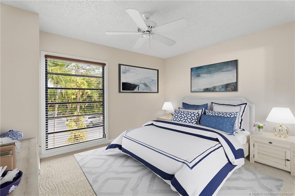 4761 Southeast Binnacle Way, Unit 108 Stuart, FL 34997 - Photo 18 of 25 a bedroom with a large bed and a window