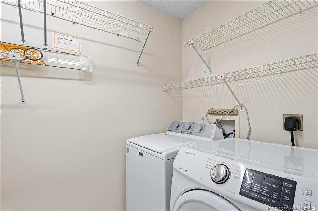 4761 Southeast Binnacle Way, Unit 108 Stuart, FL 34997 - Photo 20 of 25 a utility room with dryer and washer