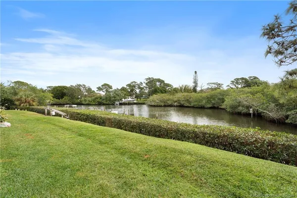 a view of a lake with houses in the back