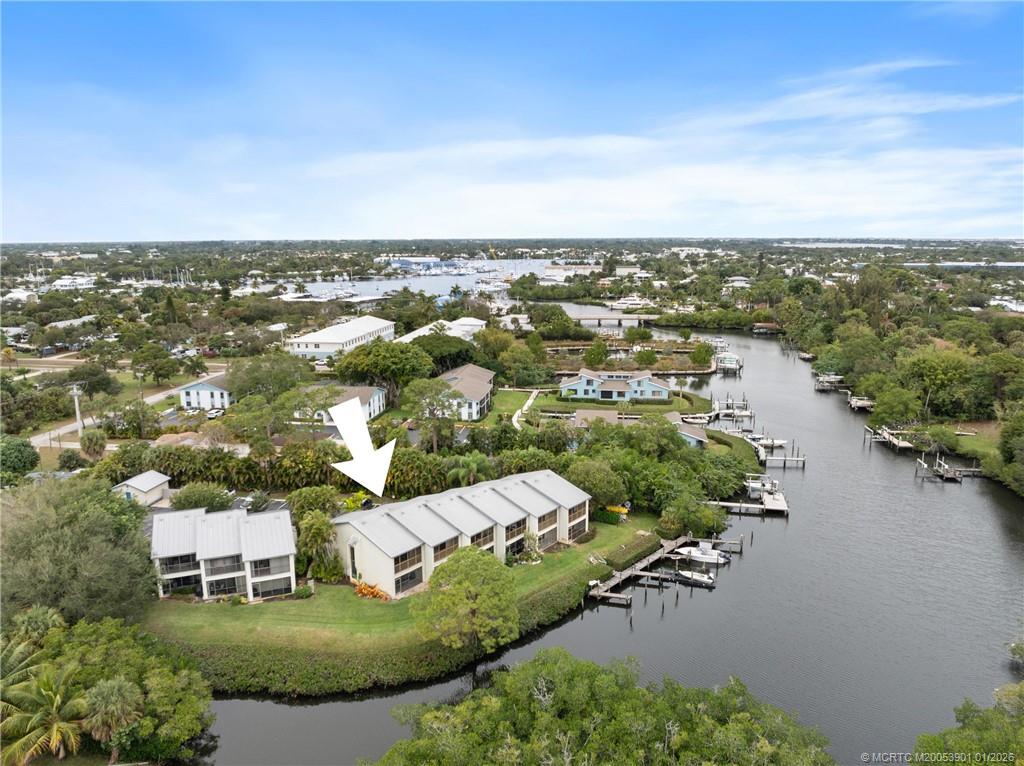 4761 Southeast Binnacle Way, Unit 108 Stuart, FL 34997 - Photo 3 of 25 an aerial view of a house with a yard and lake view in back