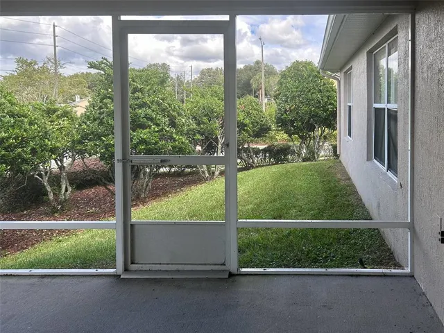 a view of a room with a large window and a large tree