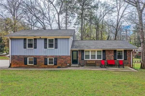 a front view of house with yard and green space