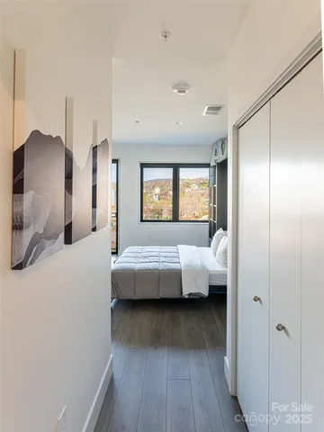 a bedroom with a bed and a large window