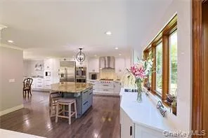 a kitchen with granite countertop kitchen island stainless steel appliances a table and chairs in it