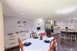 a dining room with furniture and wooden floor