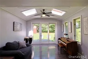 a living room with furniture a fireplace and a large window