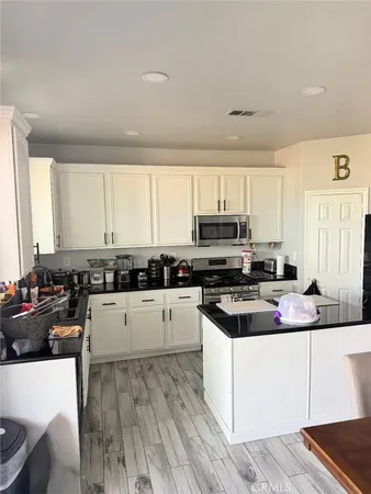 a kitchen with a stove a sink dishwasher and a refrigerator