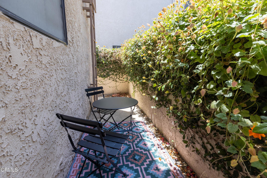 12007 Rochester Avenue, Unit 1 Los Angeles, CA 90025 - Photo 29 of 32 a house with table and chairs in patio