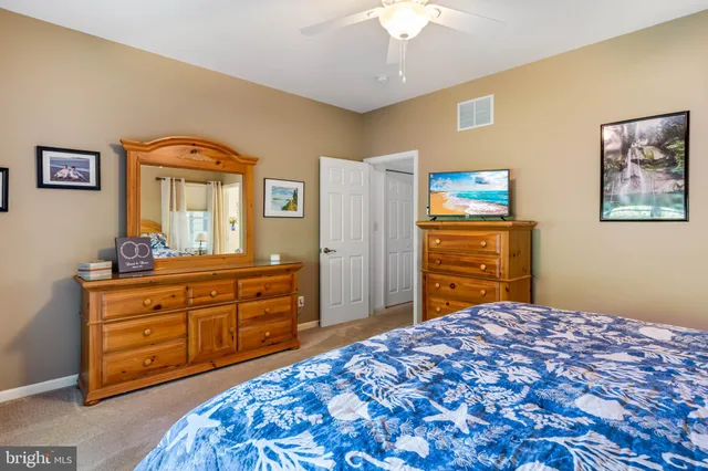a bedroom with a bed and a dresser in it