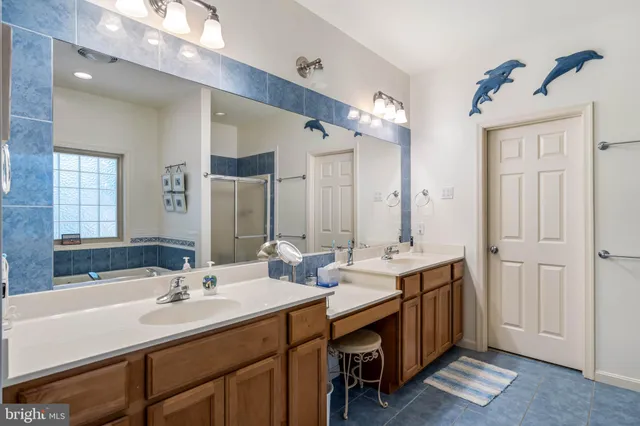 a bathroom with a double vanity sink mirror and