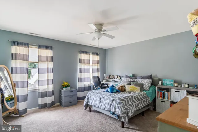 a bedroom with bed and a window