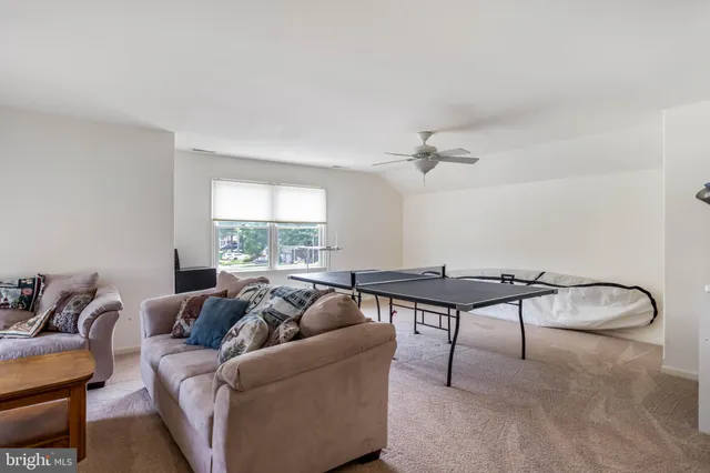a living room with furniture a rug and a window