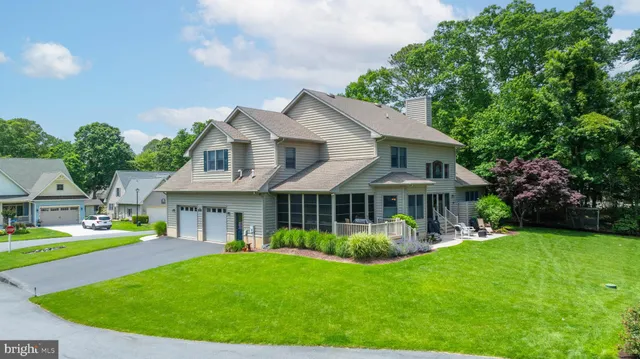 a view of a house with a yard and potted plants