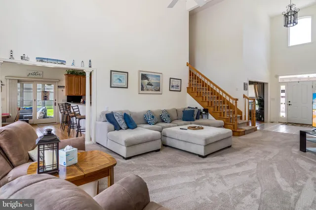 a living room with furniture or wooden floor and a flat screen tv