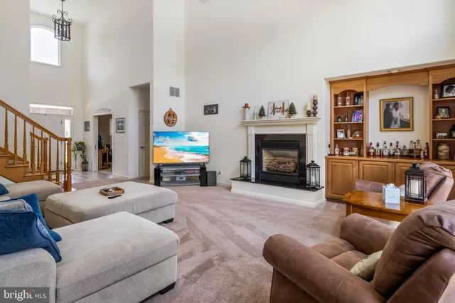 a living room with furniture fireplace and a window