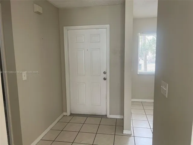 a view of a house with backyard and tree s