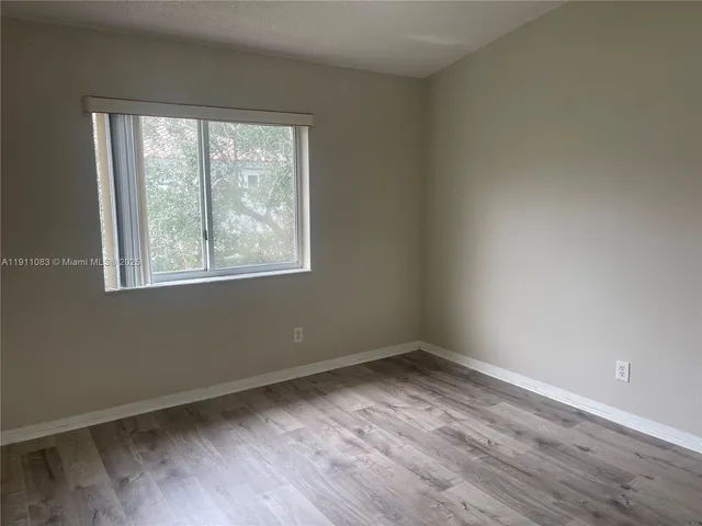 an empty room with closet and a bathroom