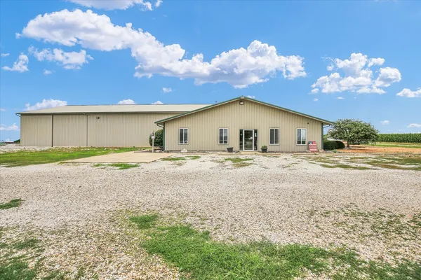 a house with swimming pool in front of it