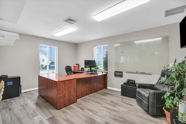 a view of a dining room with a table and chairs