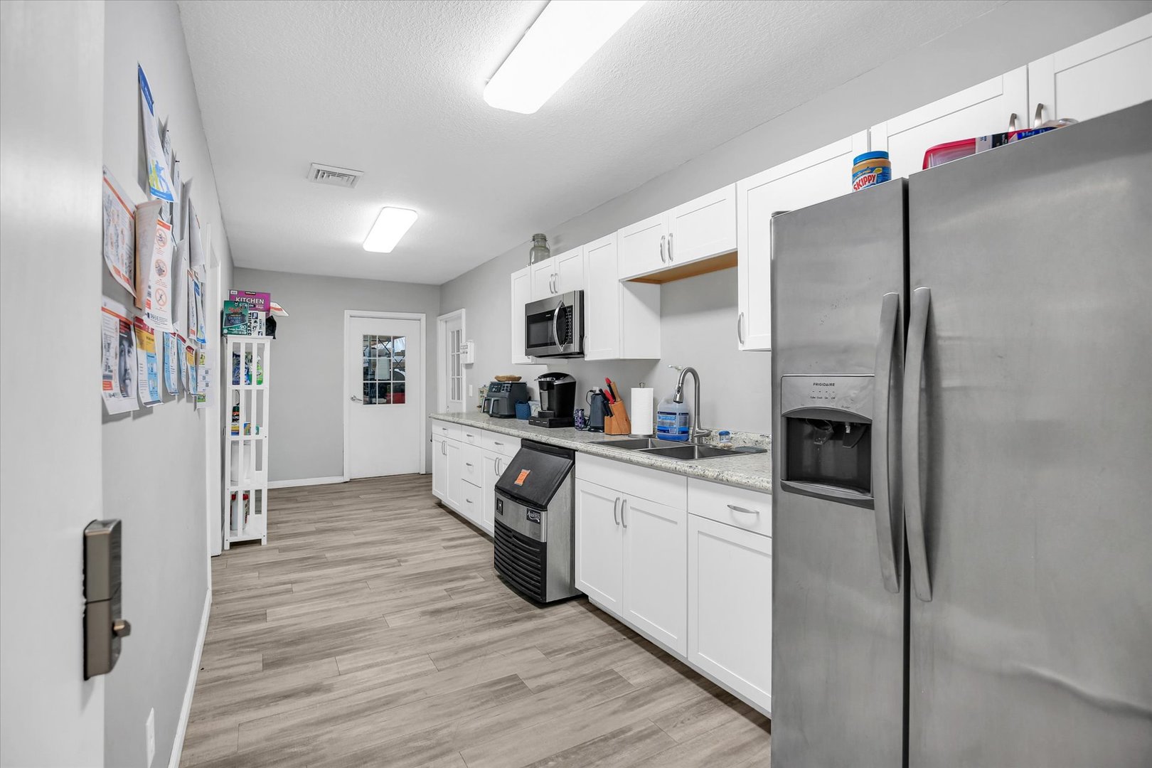 1069 County Road 900 East Champaign, IL 61822 - Photo 7 of 16 a kitchen with stainless steel appliances a refrigerator sink and microwave