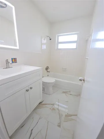 a bathroom with a sink a toilet and a bathtub