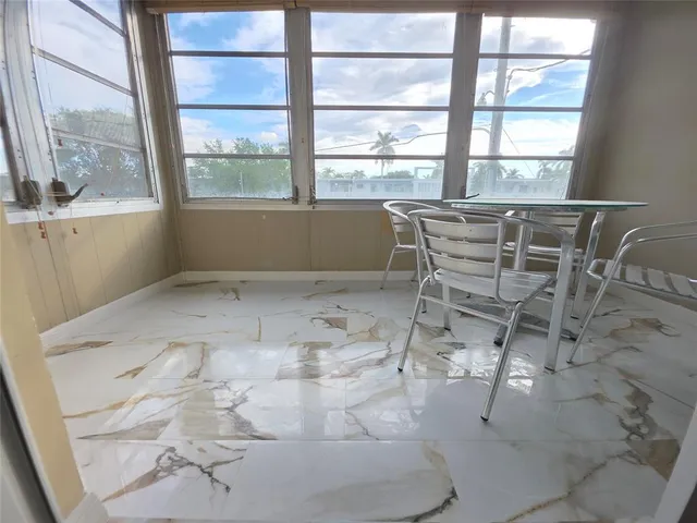a view of a dining room with furniture and windows