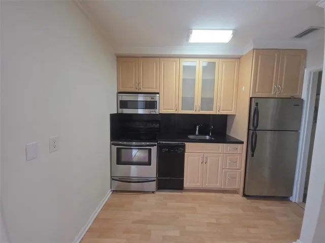 a kitchen with a refrigerator stove and microwave