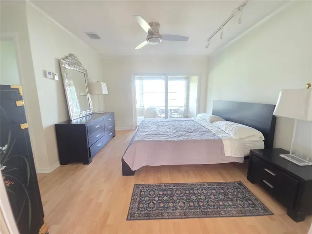 a bedroom with a bed rug and window