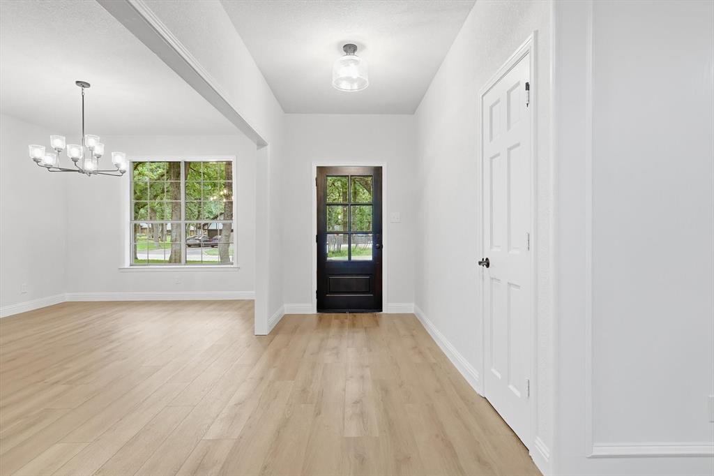 19 Timbergreen Circle Denton, TX 76205 - Photo 3 of 40 wooden floor in an empty room with a window