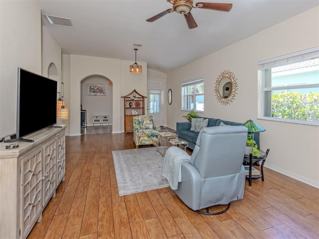 205 Reclinata Circle Venice, FL 34292 - Photo 13 of 62 a living room with furniture and a flat screen tv