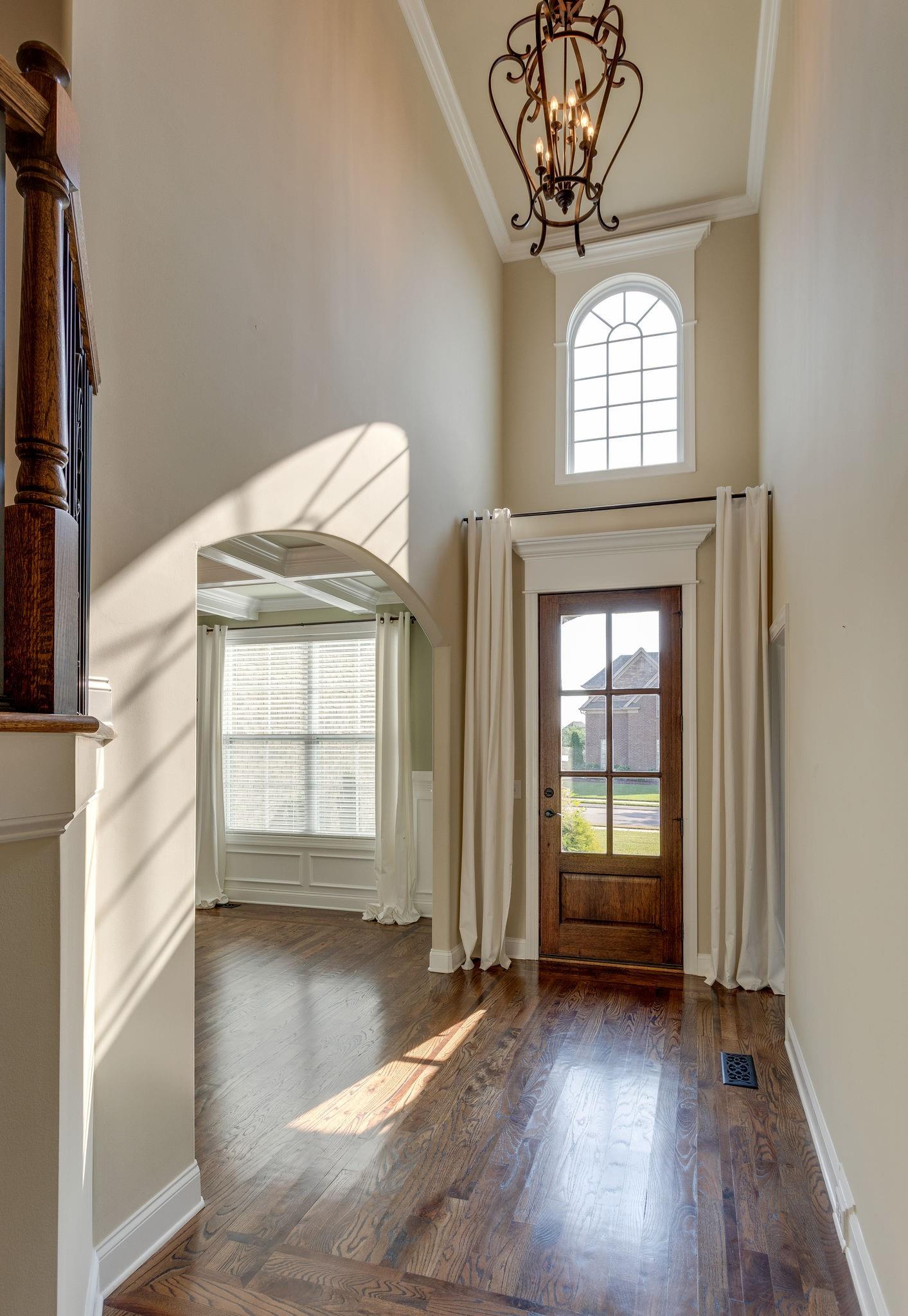 Two story foyer.  Sand and finish floors have beautiful in-lays here.