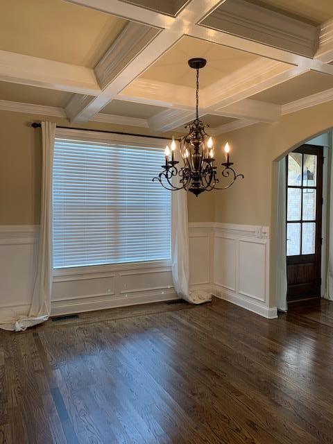 Beautiful dining room freshly painted with coffered celings.