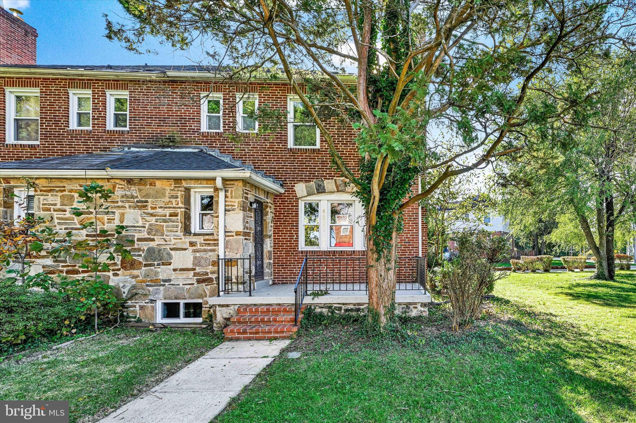 4811 Coleherne Road Baltimore, MD 21229 - Photo 1 of 28 a front view of a house with a garden