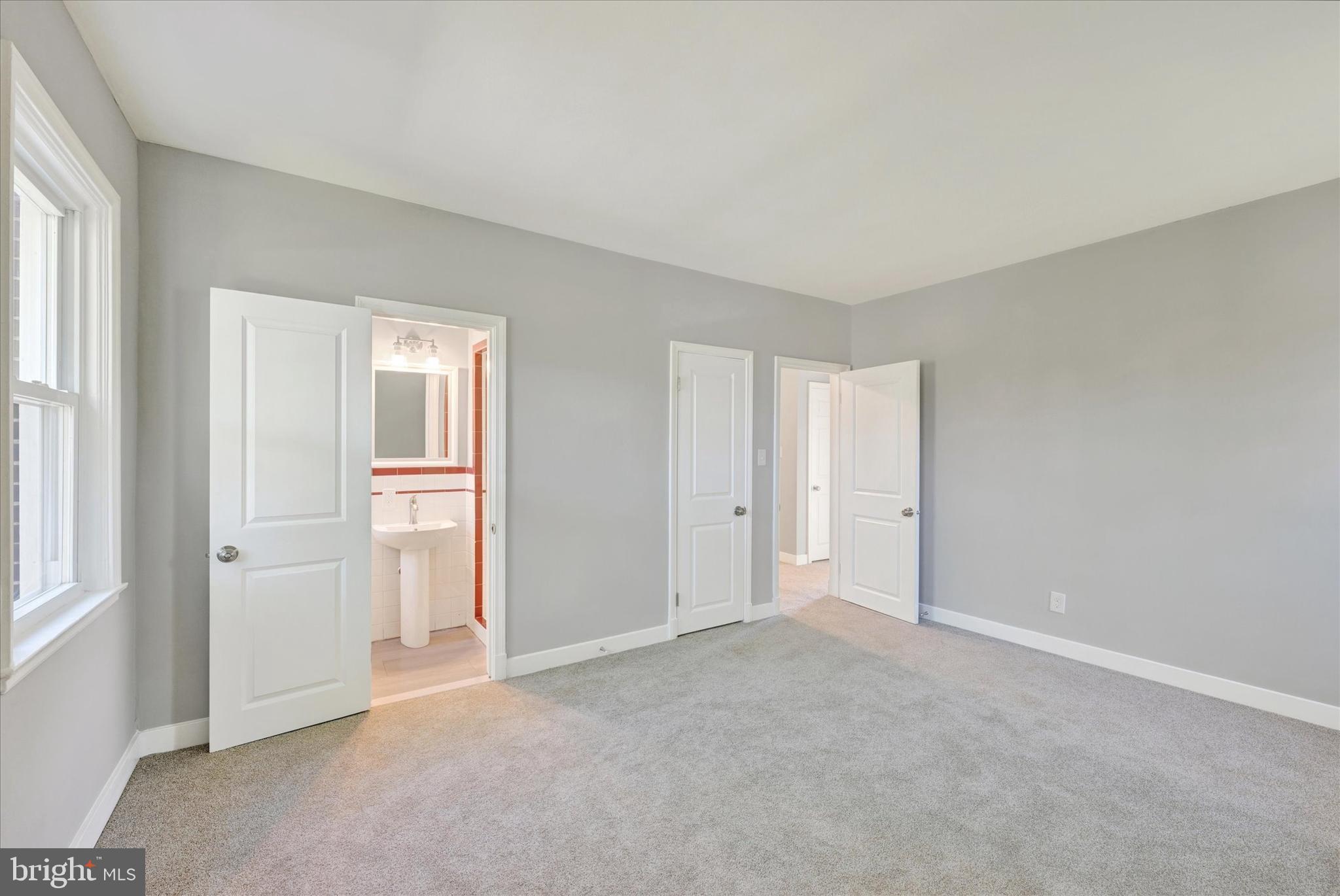4811 Coleherne Road Baltimore, MD 21229 - Photo 17 of 28 an empty room with windows and closet