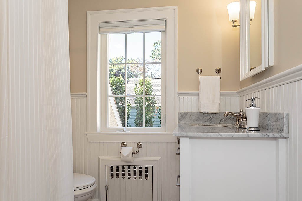 23 Jefferson Road Winchester, MA 01890 - Photo 18 of 30 a bathroom with a granite countertop sink toilet and mirror