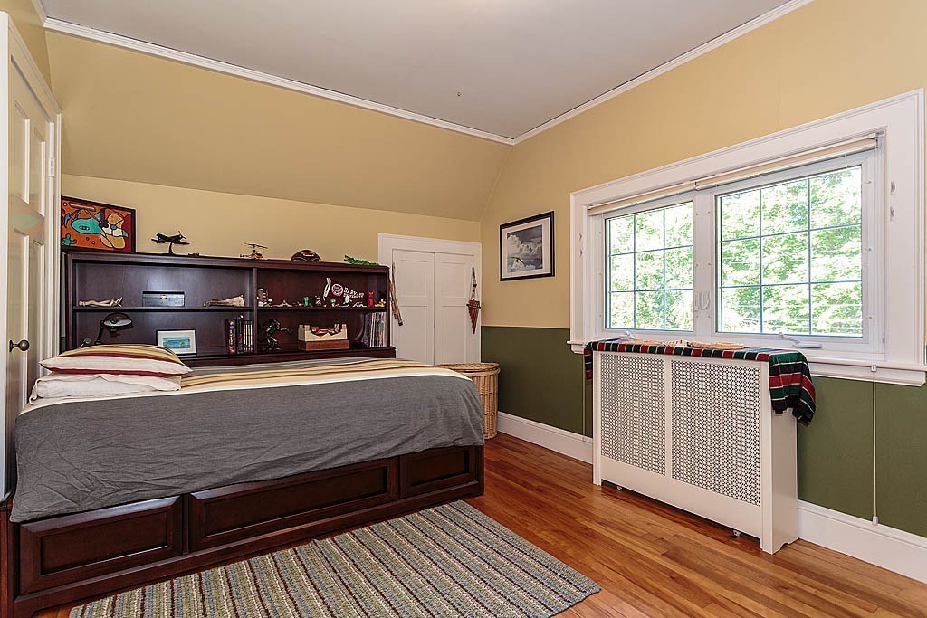 23 Jefferson Road Winchester, MA 01890 - Photo 20 of 30 a bedroom with a bed and wooden floor