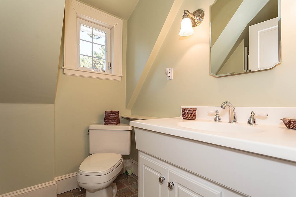 23 Jefferson Road Winchester, MA 01890 - Photo 25 of 30 a bathroom with a toilet sink and mirror