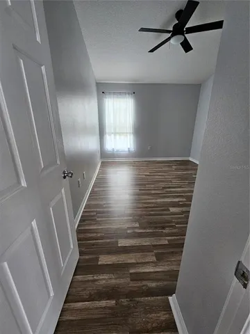 a bathroom with a granite countertop sink mirror vanity and toilet