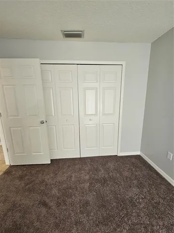 a kitchen with granite countertop a refrigerator and a stove top oven