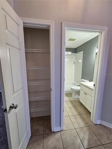 a view of backyard with tub and wooden fence