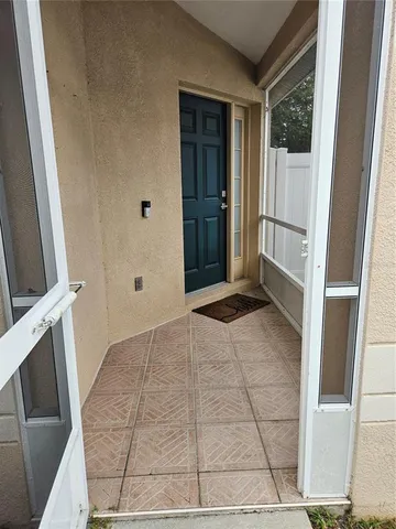 an empty room with windows and closet area