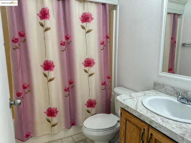 a bathroom with a sink mirror vanity and toilet