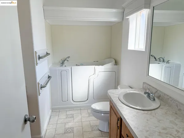 a bathroom with a sink toilet and a mirror
