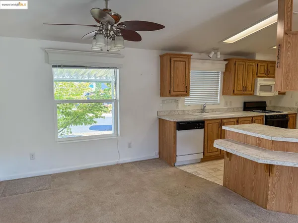 a kitchen with a stove a sink and a window