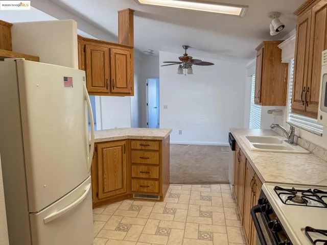 a kitchen with a refrigerator and a stove
