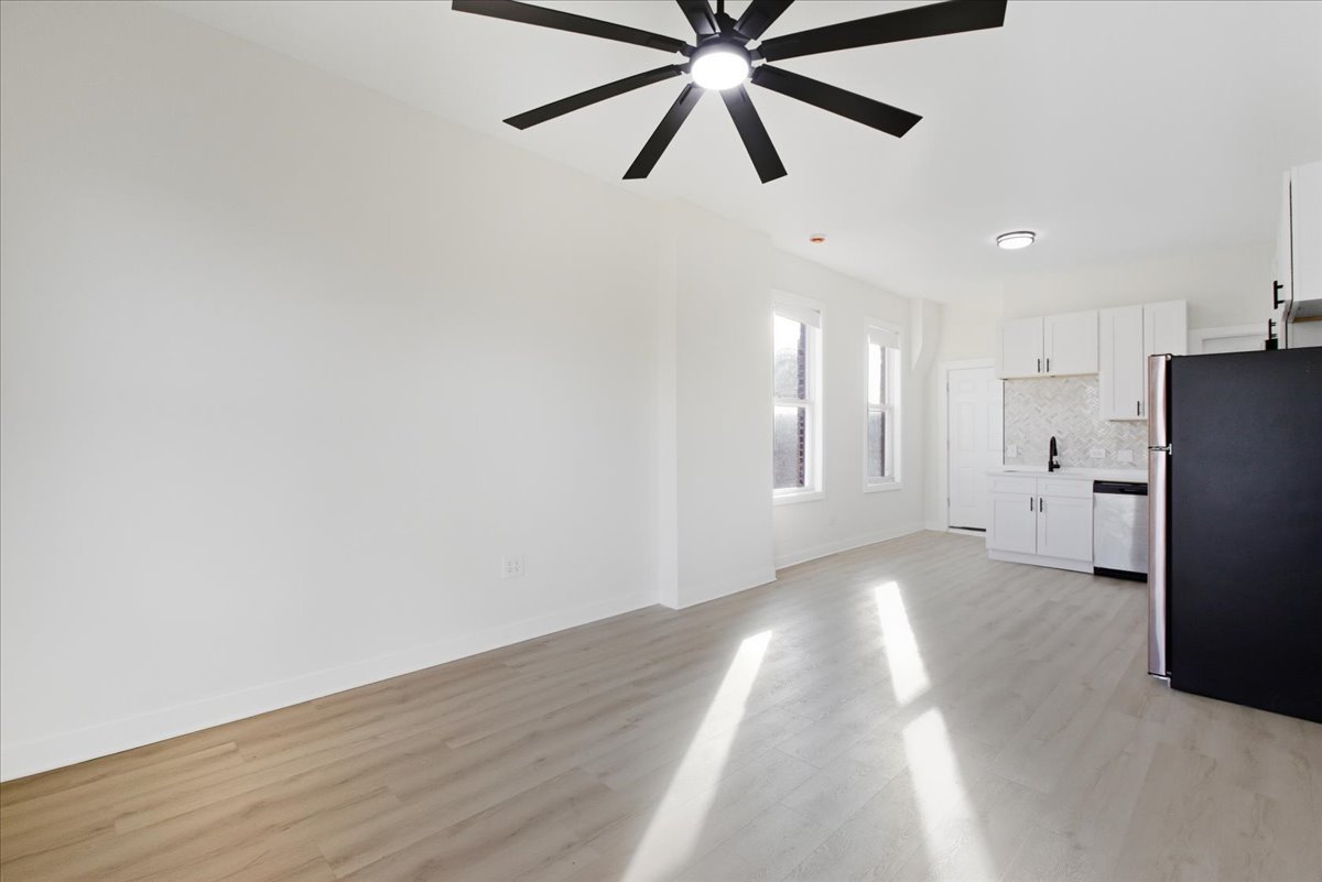 1322 West Ohio Street, Unit 2R Chicago, IL 60642 - Photo 5 of 10 a view of an empty room with wooden floor and window
