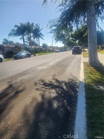 a view of a street with a yard