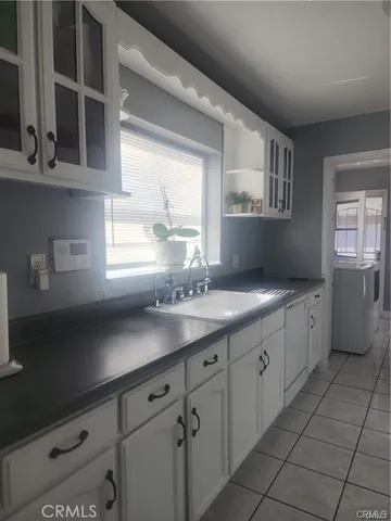 a spacious bathroom with a granite countertop sink mirror and cabinets