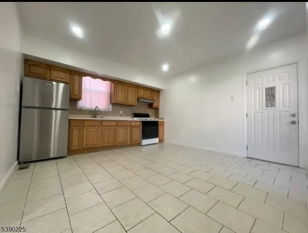 a spacious bathroom with a toilet sink and mirror