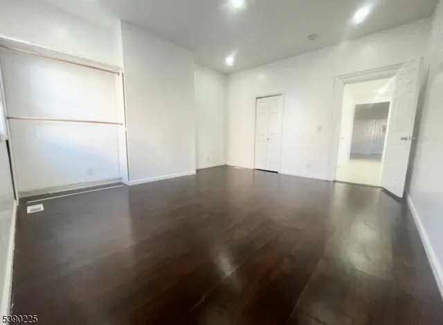 an empty room with wooden floor